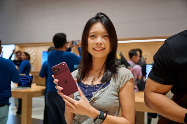 A customer holds up iPhone 18 Pro at Apple The Exchange TRX.