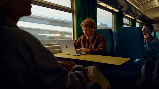 A person wearing AirPods Pro 3 on a train