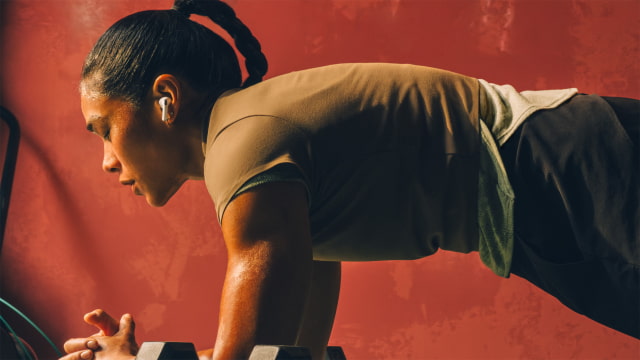 An athlete wearing AirPods Pro 3 during a workout