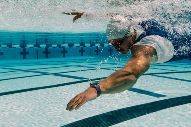 A swimmer wearing Apple Watch Series 12 in a pool