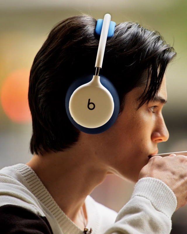 A listener wearing Beats 360 with contrasting ear cushions