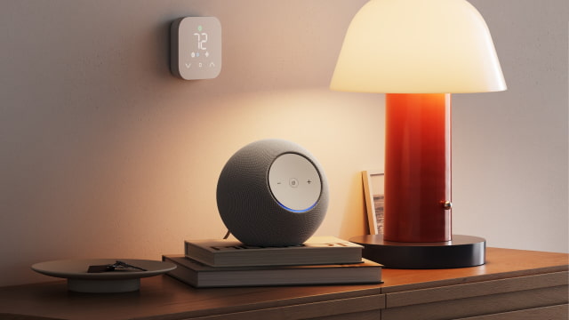 Echo Studio speaker beside a lamp